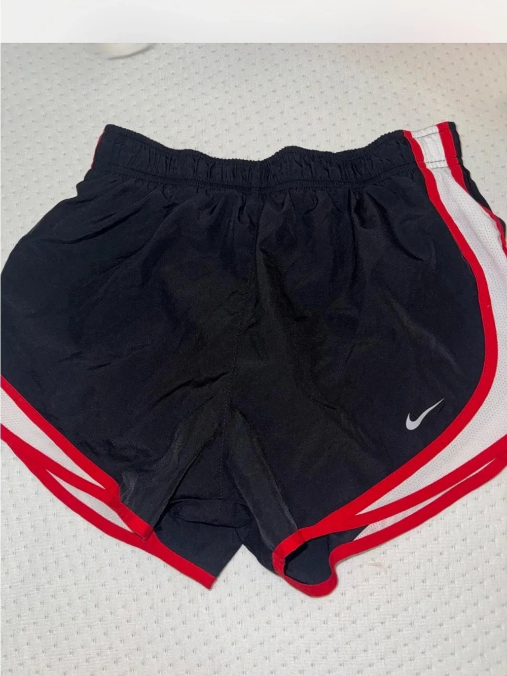 Nike Black Athletic Shorts with Red Trim and White Swoosh